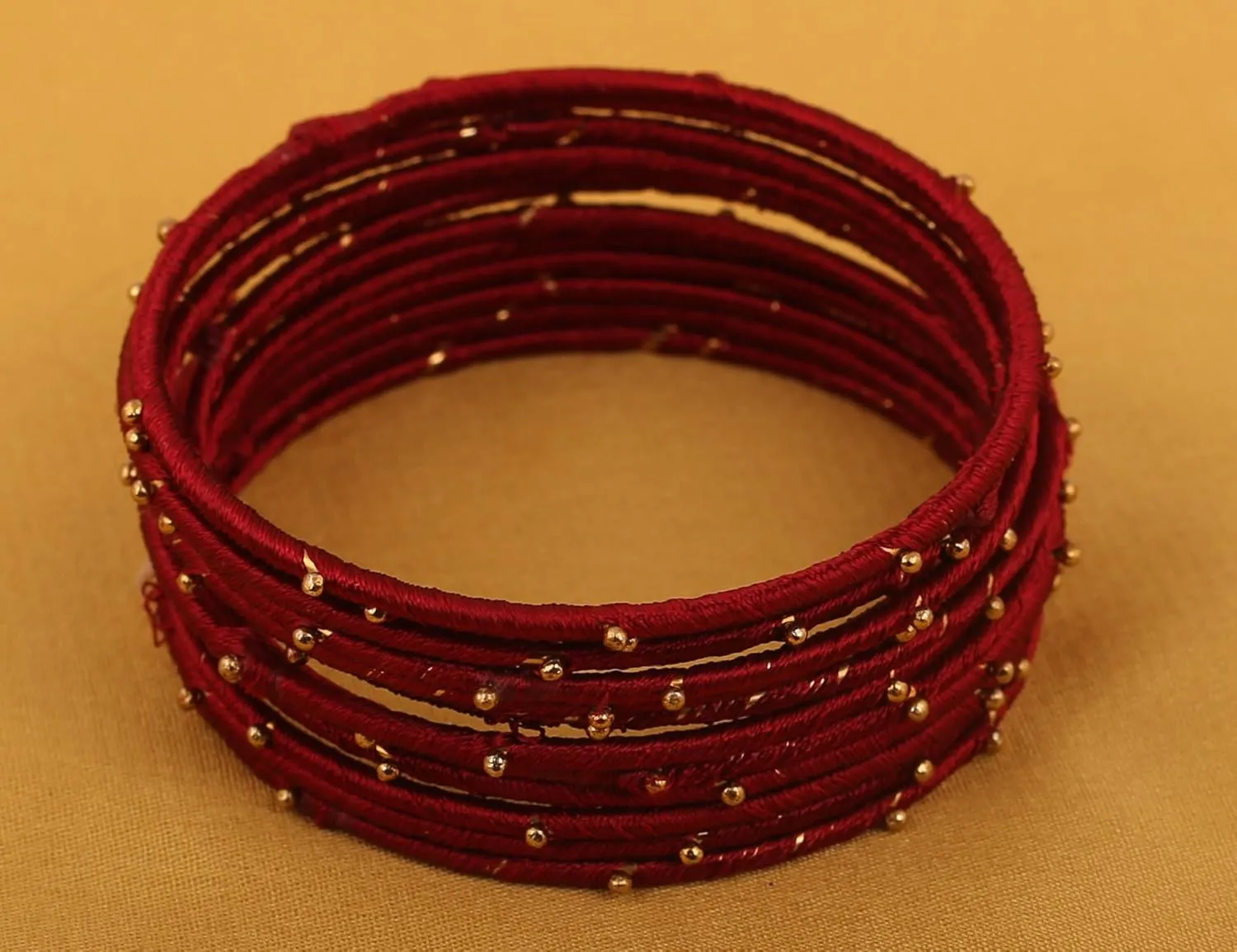 Touchstone Indian Bollywood Mystical Look Hand Woven Faux Silk Thread Golden Balls Gorgeous Color Exotic Designer Jewelry Bangle Bracelets for Women.